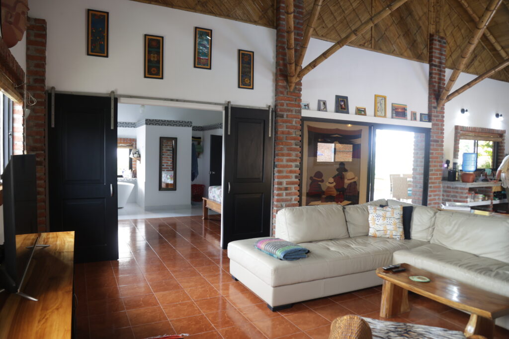 Main living area with hanging barn doors leading to master bedroom